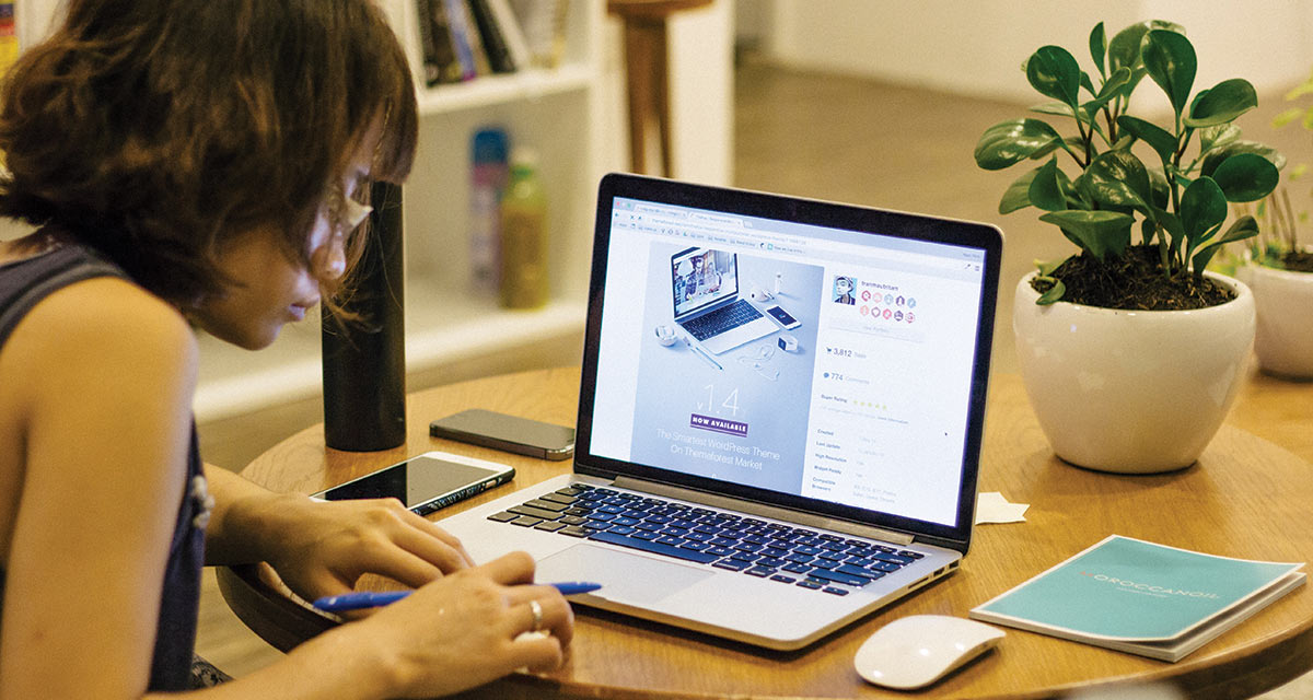 a woman at a desk with a laptop