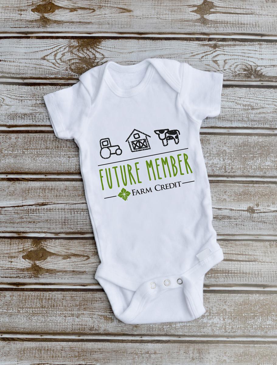 Future Member text with crayon drawings of cow, barn and tractor shown on white baby onesie 