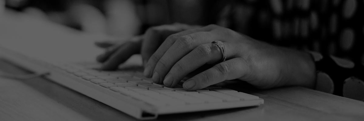 a woman typing on a computer keyboard