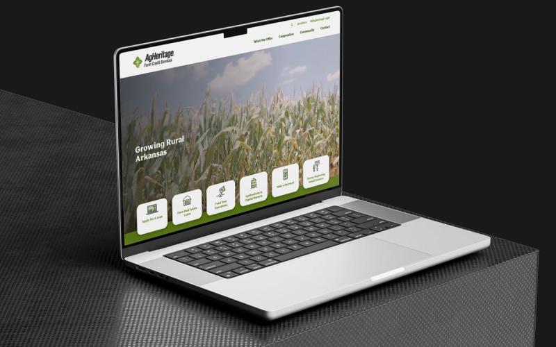 Agheritage website mockup on laptop sitting on black table 